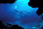 A Scuba Diver, photographed from a cave mouth on Astrolabe Reef, Kadavu, Fiji.
