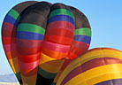 Inflating balloons display striking color and form.