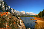 Orange lichens on boulder and Mount Cephren on Lower Waterfowl Lake, Banff National Park.