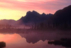 Sunrise and morning mist at Third Vermilion Lake, Banff National Park.